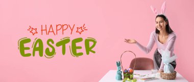 Paskalya yumurtalarını pembe arka planda boyayan genç bir kadınla pankart. 