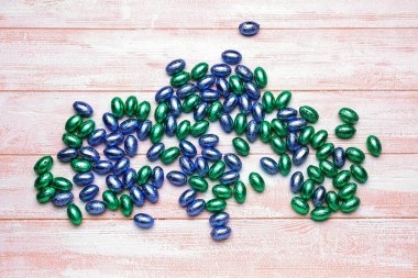 Hafif ahşap arka planda bir yığın çikolata Paskalya yumurtası.