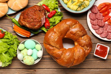 Tasty dishes for Easter dinner on wooden table