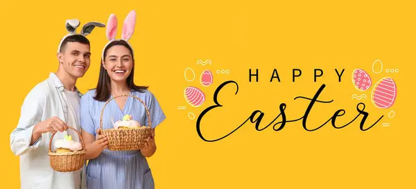 一对快乐的年轻夫妇 长着小兔子耳朵和黄色背景的复活节篮子 复活节贺卡横幅 — 图库照片