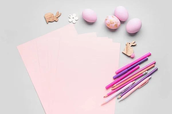 Blank Paper Sheet Rabbits Pens Easter Eggs Grey Background — Zdjęcie stockowe