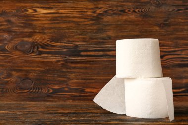 Ahşap arka planda tuvalet kağıdı ruloları