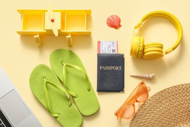 Renkli plaj aksesuarları, pasaport, bilet ve kulaklık içeren kompozisyon
