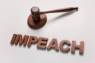 Judge gavel and word IMPEACH on white background