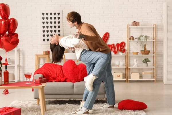 Young couple dancing at home. Valentine\'s day celebration