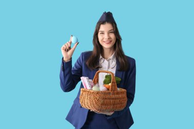 Mavi arka planda Paskalya yumurtaları olan güzel hostes.