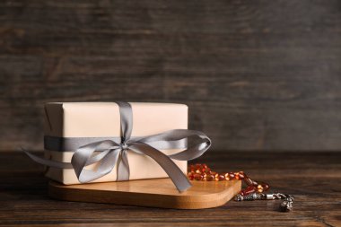 Tahta masada Ramazan için dua boncukları olan bir hediye kutusu.