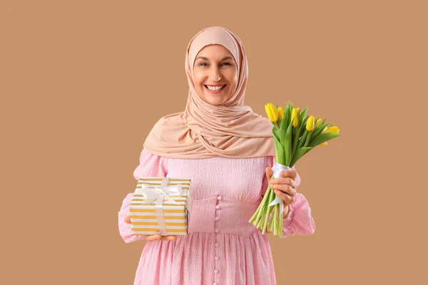 Starší Muslimka Tulipány Dárek Hnědém Pozadí Ramadánská Oslava — Stock fotografie