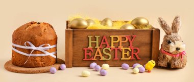 Lezzetli Paskalya pastası, boyanmış yumurta, tavşancık ve bej arka planda ahşap kutu.