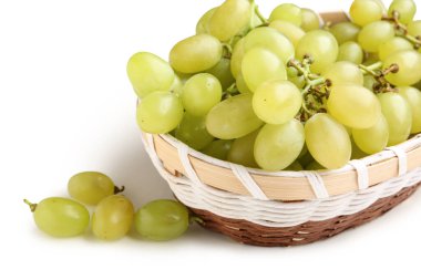 Beyaz arka planda taze yeşil üzümlü hasır kase.