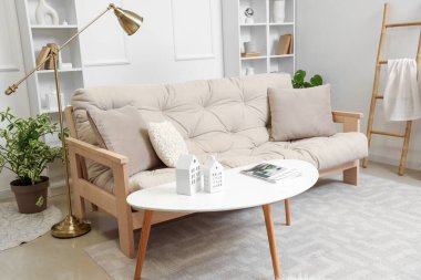 Işıl ışıl oturma odası, rahat beyaz kanepe ve kahve masası.