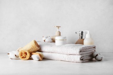 Hafif arkaplanda spa aksesuarları, kozmetik ürünleri ve pamuk çiçekleri olan kompozisyon