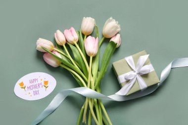 Mutlu Anneler Günü yazılı kart, hediye kutusu ve gri arka planda lale çiçekleri