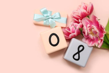 Küp takvimi, tarih 08, güzel laleler ve pembe arka planda hediye kutusu. Uluslararası Kadınlar Günü