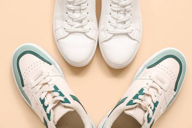 Bej arka planda farklı şık spor ayakkabılar