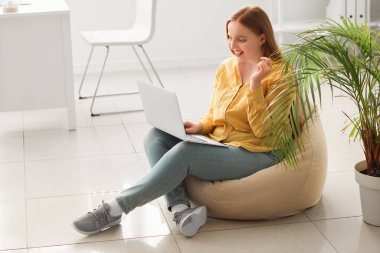 Ofiste dizüstü bilgisayarla çalışan kadın programcı