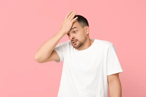 Handsome Worried Young Man Covering Face Hand Pink Background — Stock Photo, Image