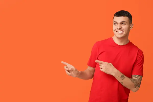 Handsome Ashamed Young Man Pointing Something Orange Background — Stock Photo, Image