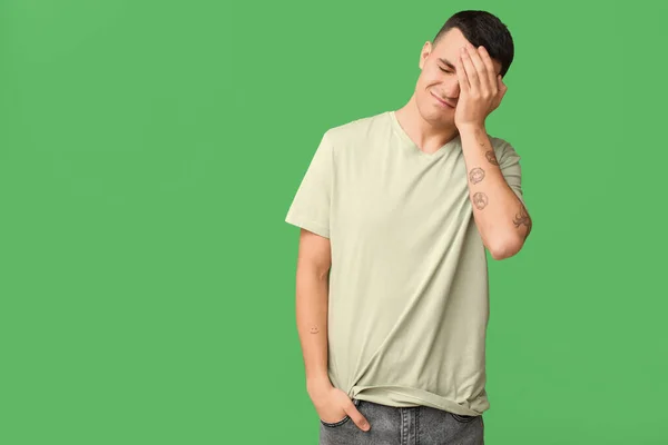 Handsome Ashamed Young Man Covering Face Hand Green Background — Stock Photo, Image