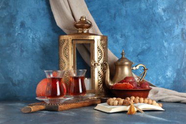 Türk çayı, meyve, Kuran, tespih ve mavi masada. Ramazan kutlaması