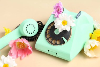 Retro telefon ve bej arka planda güzel çiçekler. Uluslararası Kadınlar Günü