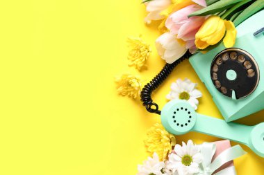Hediye kutusu ve sarı arka planda güzel çiçekler olan Retro telefon. Uluslararası Kadınlar Günü