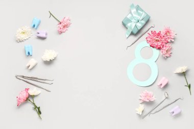Gri arkaplanda dişçi aletleri, çiçekler ve figür 8 olan kompozisyon. Uluslararası Kadınlar Günü
