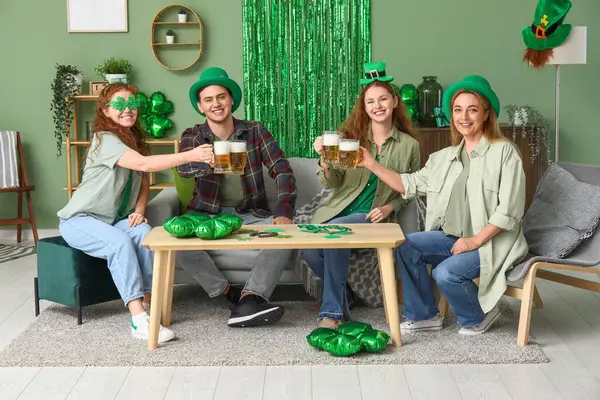 Group of people drinking beer at home. St. Patrick's Day celebration