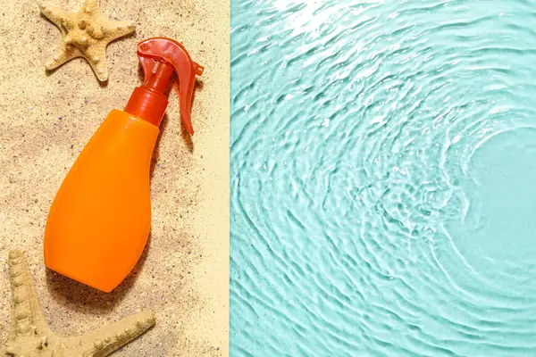 Spray bottle with sunscreen cream on edge of swimming pool