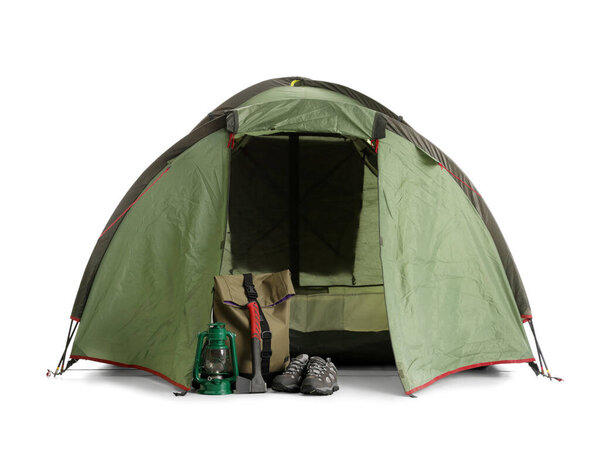Camping tent with hiking equipment on white background