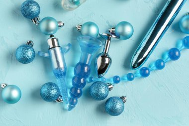 Turkuaz arka planda seks oyuncakları ve Noel ağacı topları