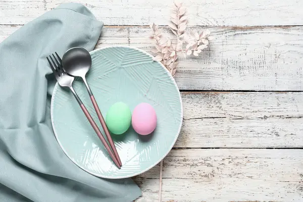 Paskalya için çok güzel bir sofra. Yumurtalar ve hafif ahşap arka planda dallar.