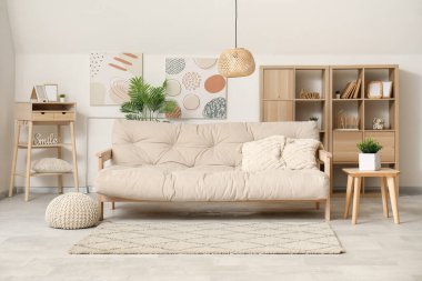 Rahat kanepesi, rafları ve masası olan aydınlık oturma odasının içinde.