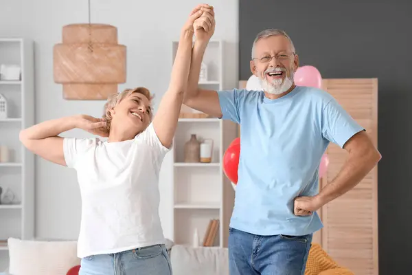 Mature couple dancing at home on Valentine's Day