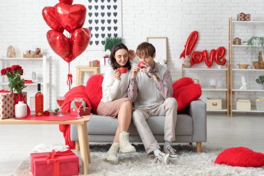 Evde kahve içen genç bir çift. Sevgililer Günü kutlaması