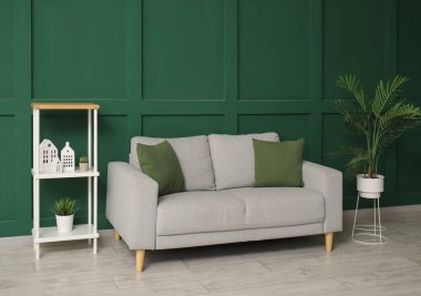 Rahat kanepesi, çiçekleri ve rafları olan şık bir oturma odası.