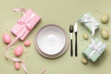 Yeşil arka planda hediyeler ve yumurtalarla güzel Paskalya sofrası
