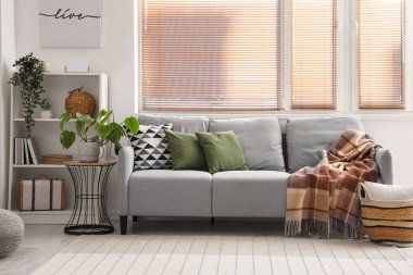 Oda çiçekleri olan rahat bir kanepe.