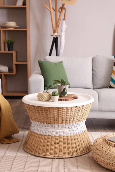 Wicker table with different home decor in stylish living room