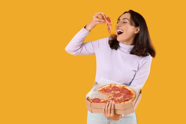 Young Woman Eating Tasty Pepperoni Pizza Yellow Background — Stock Photo, Image