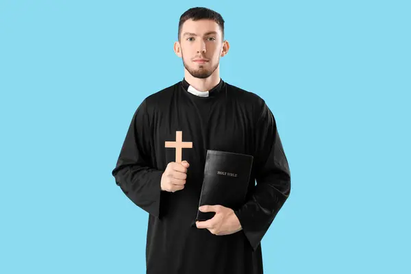 Young Priest Holy Bible Cross Blue Background — Stock Photo, Image