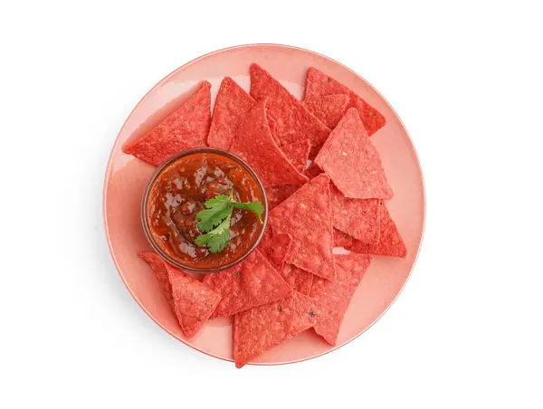 Plate with tasty red nachos and salsa sauce on white background
