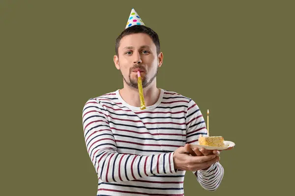 Man with birthday cake and party whistle on color background