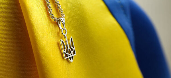 Ukrainian coat of arms pendant and flag, closeup