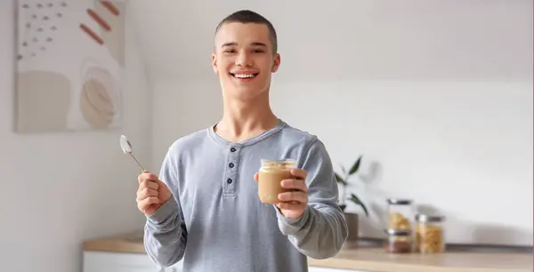 Happy Young Man Tasty Nut Butter Kitchen — Stock Photo, Image