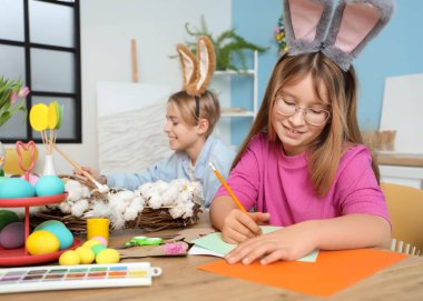 Odada Paskalya zanaatı yapan tatlı küçük kız.
