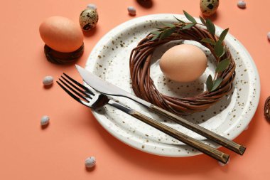 Turuncu arka planda Paskalya yumurtaları olan güzel bir masa.