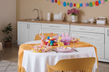 Mutfaktaki Paskalya kutlaması için boyanmış yumurta ve tavşanlarla servis edilen şenlikli masa.