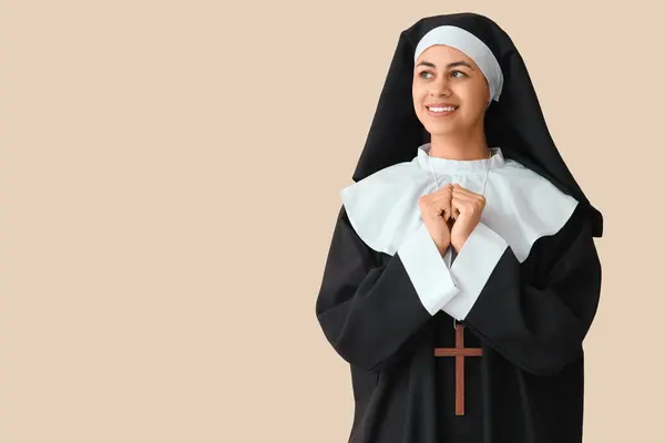 stock image Young nun on beige background