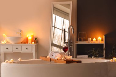 Odada şarap, havlu ve yanan mumlarla dur.